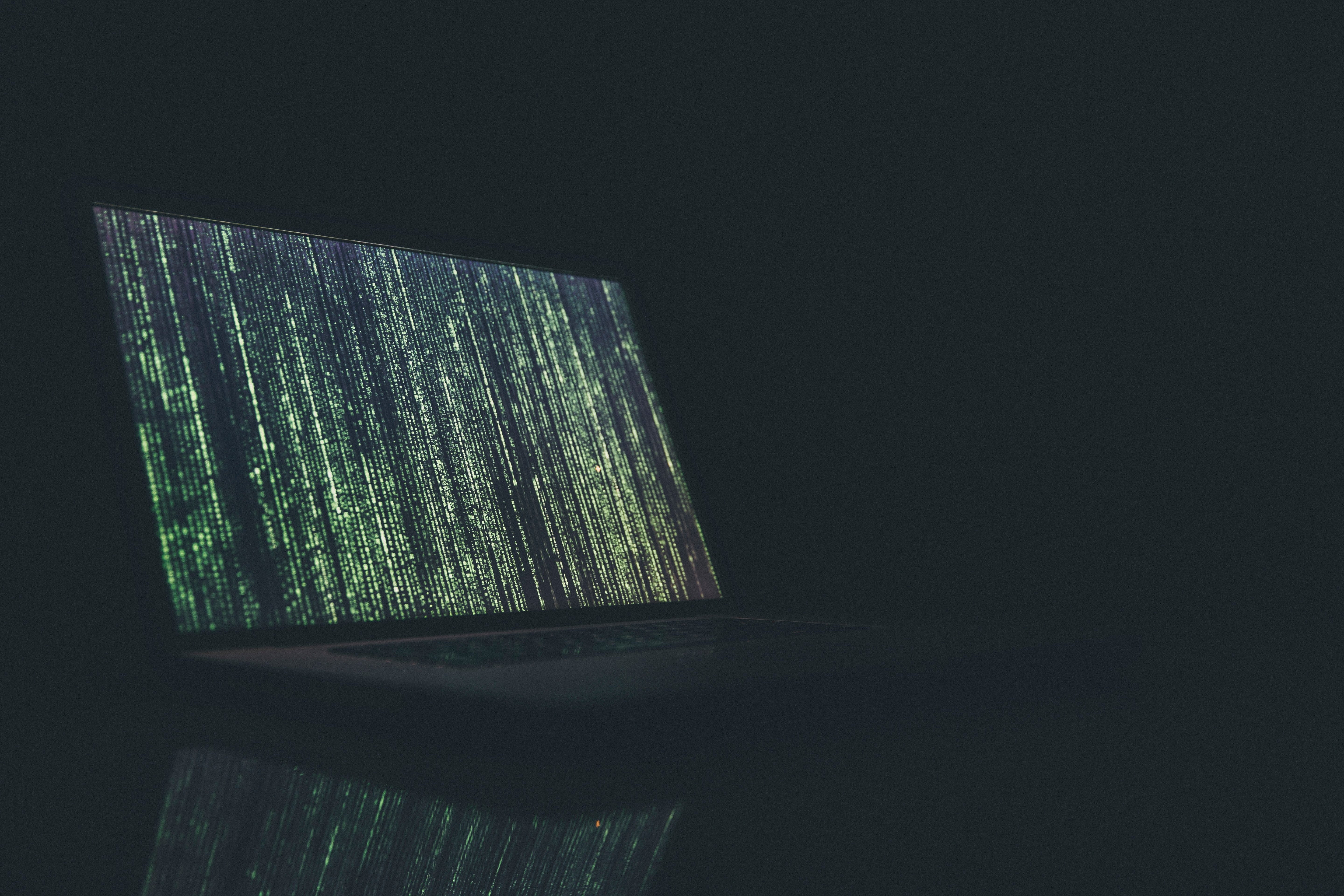 Laptop with green code in dark Laptop with green code in dark