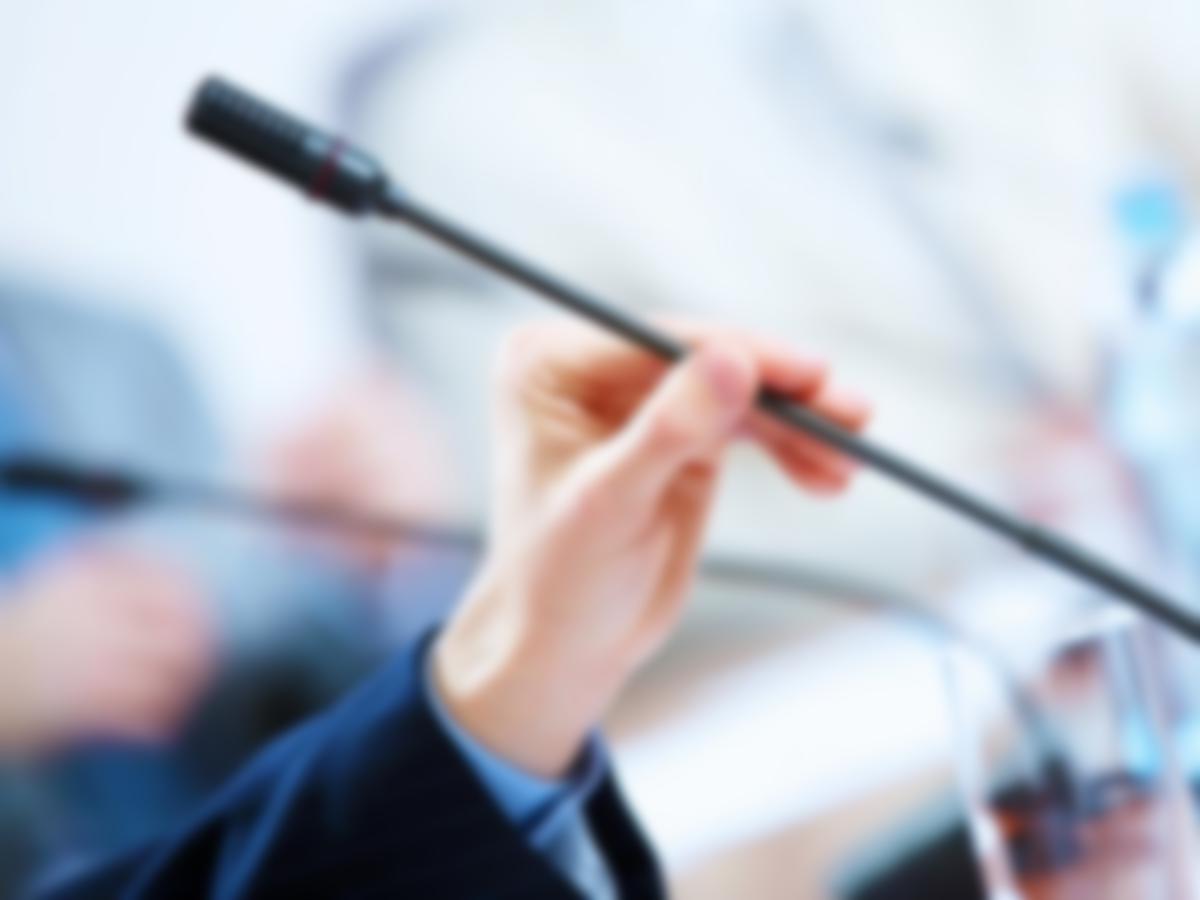 before a conference, the microphones in front of empty chairs