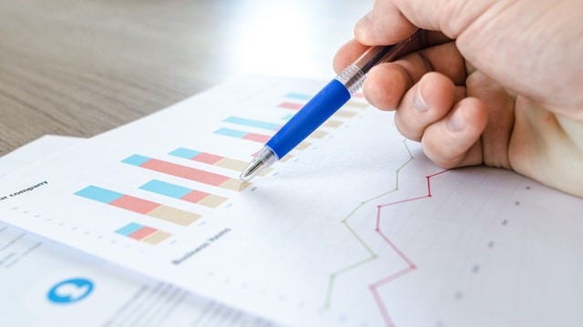 Pen pointing at charts on an analytics printout